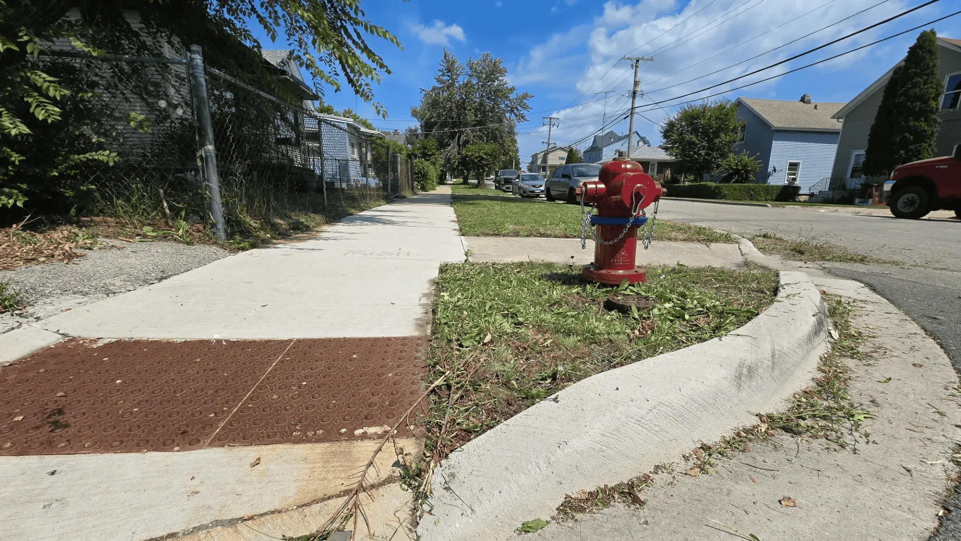 Freshly trimmed parkway and cleared sidewalk edge on a Joliet-area residential street